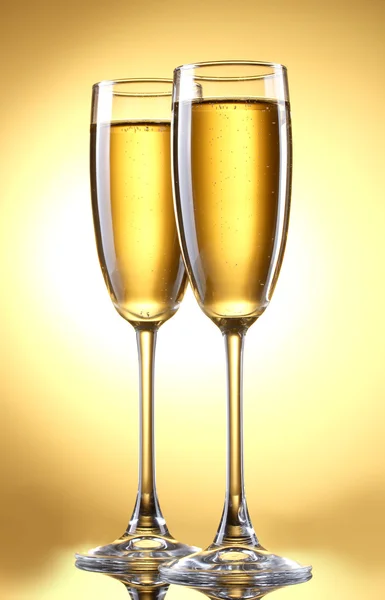 Glas champagne på gul bakgrund — Stockfoto