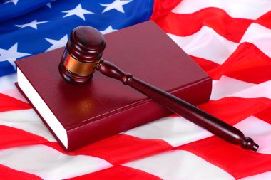 Judge gavel and book on american flag background clipart