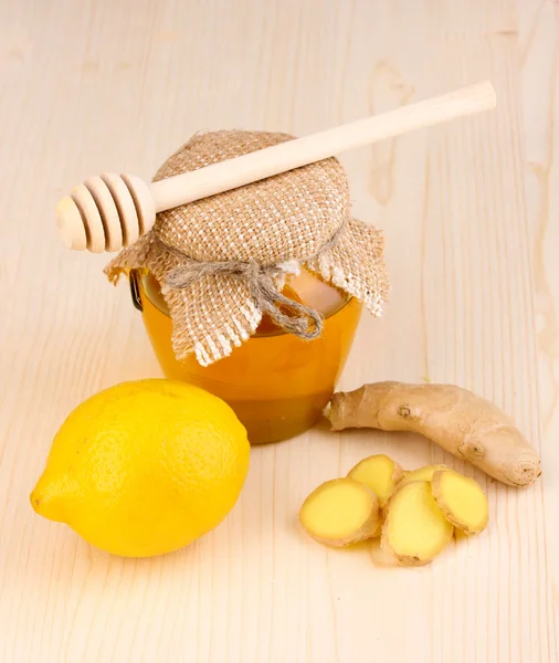 Ginger with lemon and honey on wooden background — Stock Photo, Image