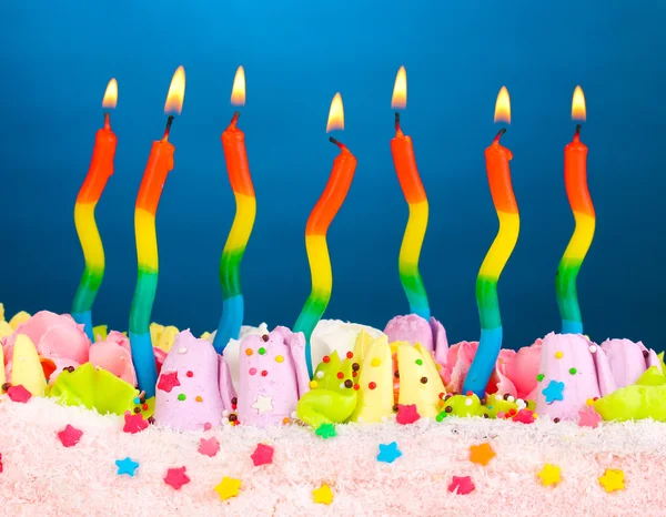 Torta di compleanno con candele su sfondo blu — Foto Stock