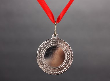 Silver medal on grey background clipart