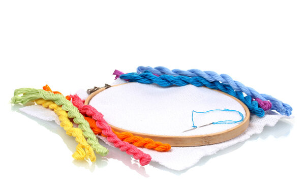 The embroidery hoop with canvas and bright sewing threads for embroidery isolated on white