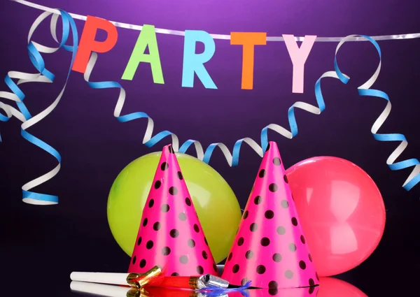 Party items on purple background — Stock Photo, Image
