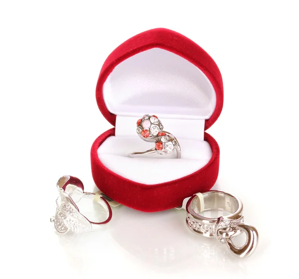 Silver ring with red, pink and clear crystals in red velvet box and some silver rings isolated on white — Stock Photo, Image