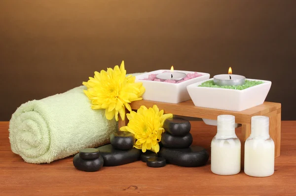 Spa setting on wooden table on brown background — Stock Photo, Image