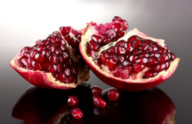 Ripe pomegranate fruit on grey background clipart