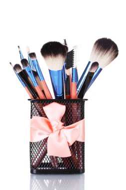 Make-up brushes in holder isolated on white