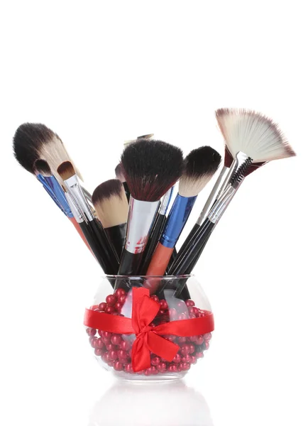 Make-up brushes in glass vase isolated on white — Stock Photo, Image