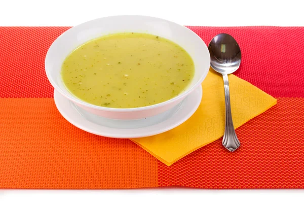 Zuppa saporita su tovaglia rossa isolata su bianco — Foto Stock