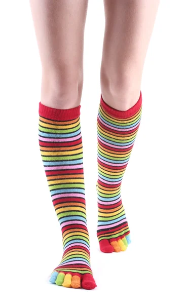 stock image Female legs in colorful striped socks isolated on white