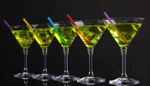 Yellow cocktail in martini glasses isolated on black — Stock Photo, Image