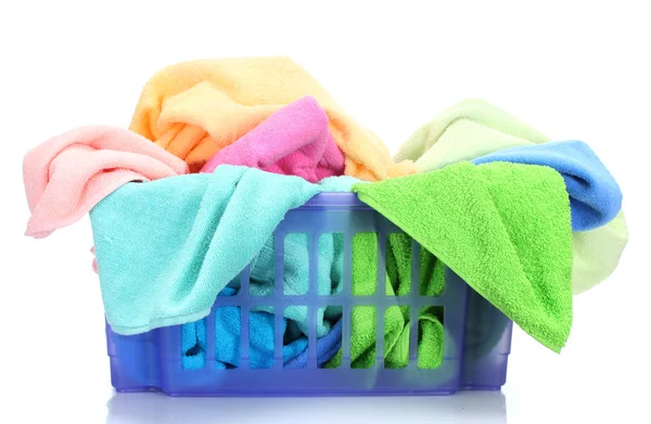 Plastic basket with bright towels isolated on white — Stock Photo, Image