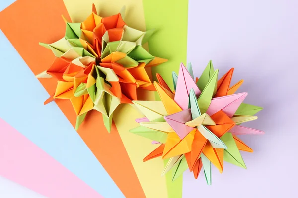 stock image Colorfull origami kusudamas on bright paper background
