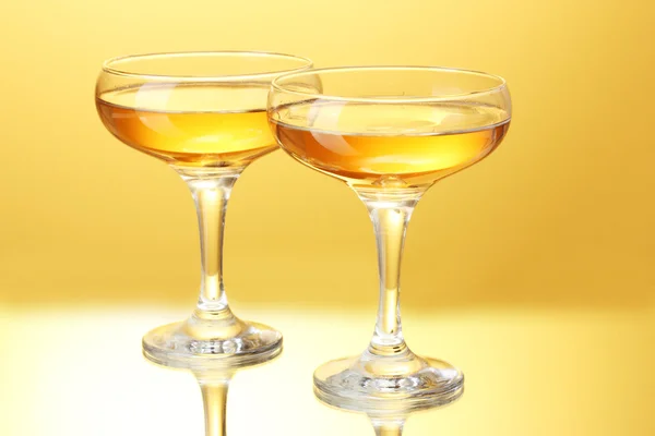 Bicchieri di champagne su sfondo giallo — Foto Stock