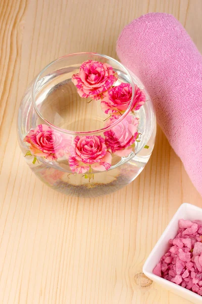 Vase with roses, spa setting on wooden background — Stock Photo, Image