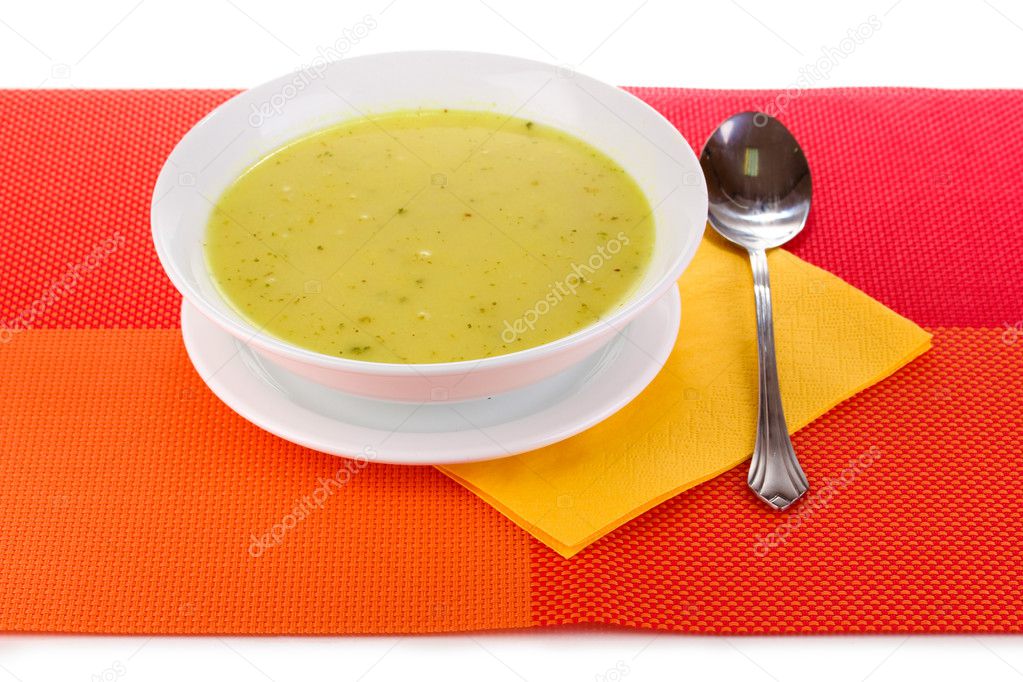 Tasty soup on red tablecloth isolated on white