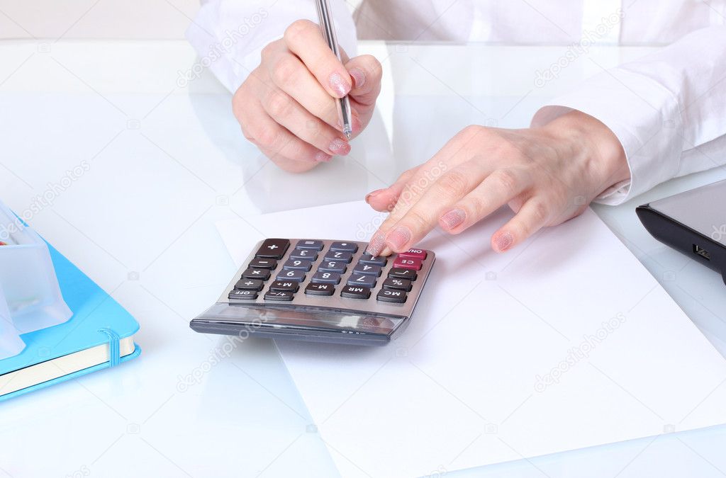 Hands and calculator
