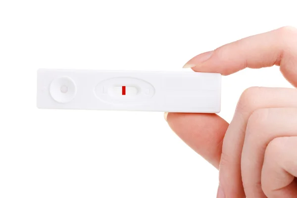 Hamilelik testi üzerine beyaz izole el — Stok fotoğraf