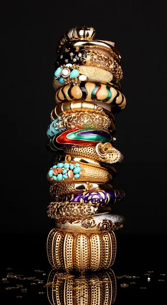 Beautiful golden bracelets isolated on black background — Stock Photo, Image