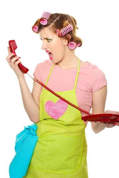Bela jovem dona de casa com telefone vermelho isolado no branco — Fotografia de Stock