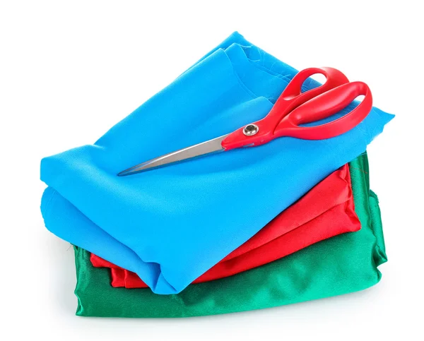 Scissors on fabric isolated on whiteblue red — Stock Photo, Image