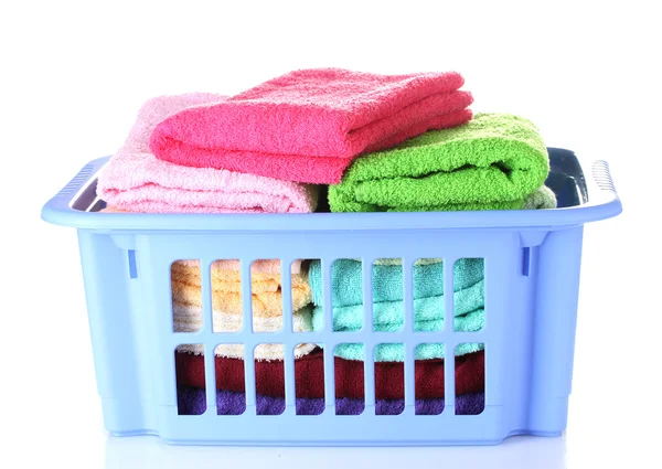 stock image Plastic basket with bright towels isolated on white