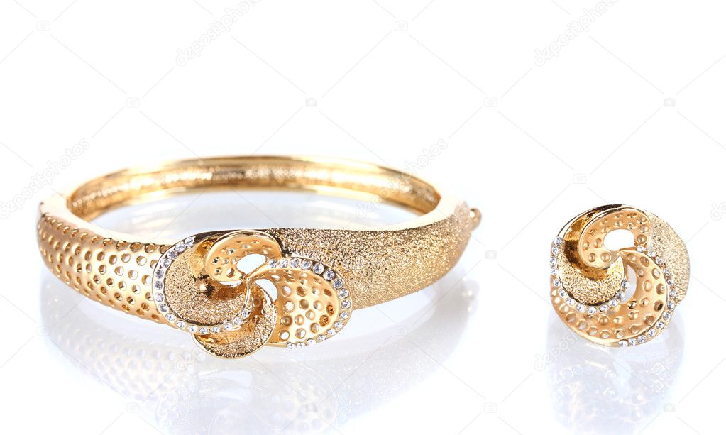 Beautiful golden bracelet and ring with precious stones isolated on white