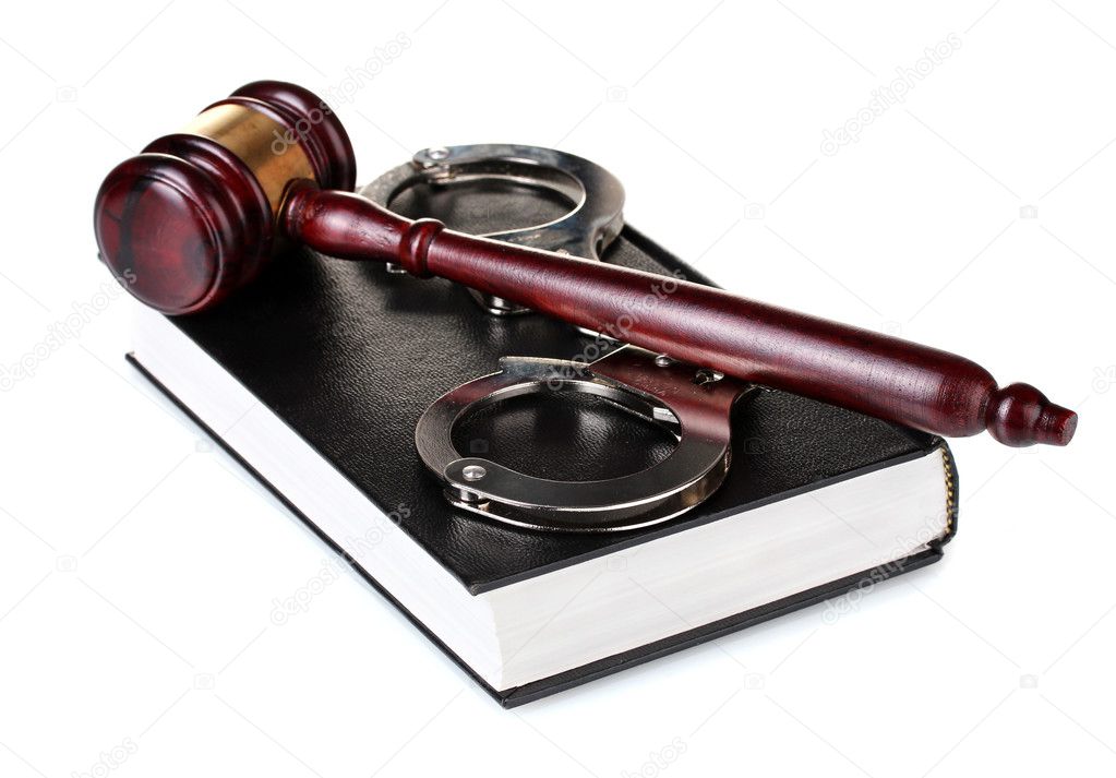 Wooden gavel, handcuffs and book isolated on white