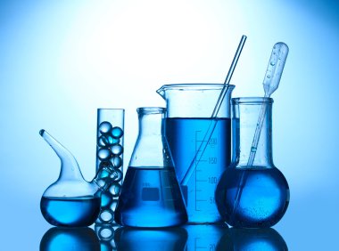 Test-tubes with blue liquid on blue background clipart