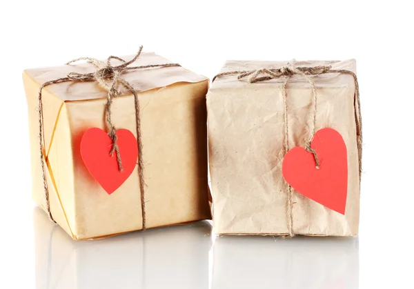 Two small parcels with blank heart-shaped labels isolated on white — Stock Photo, Image