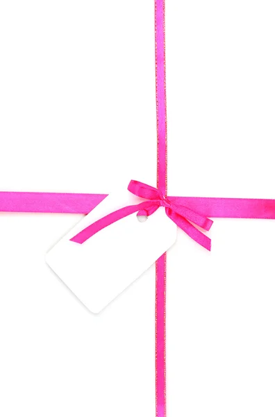Pink satin bow and ribbon with blank gift tag isolated on white — Stock Photo, Image