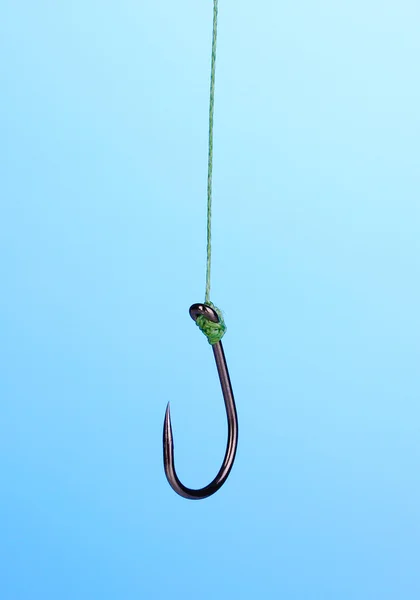 stock image Single fish hook on blue background