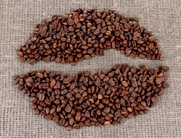 Grãos de café em um fundo saco — Fotografia de Stock