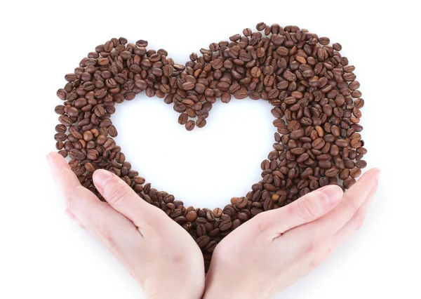 Mano che tiene il cuore di chicchi di caffè su sfondo bianco — Foto Stock