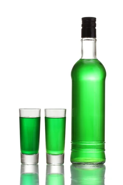 Bottle and two glasses of absinthe isolated on white — Stock Photo, Image
