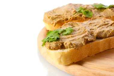 Fresh pate on bread on wooden board clipart