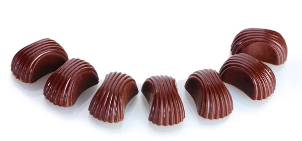 Diferentes dulces de chocolate aislados en blanco — Foto de Stock