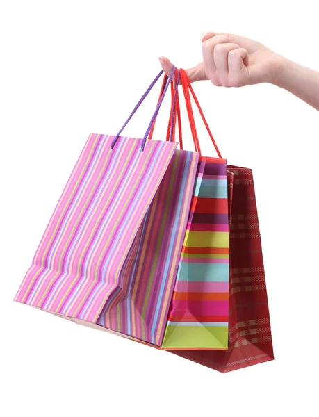Parlak alışveriş torbaları üzerinde beyaz izole tutmak el — Stok fotoğraf