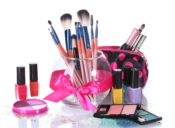 Make-up brushes in glass vase and cosmetics isolated on white — Stock Photo, Image
