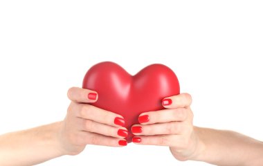 Red heart in woman's hands isolated on white clipart