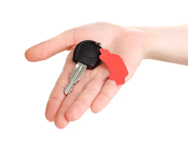 Car key with charm in hand isolated on white — Stock Photo, Image