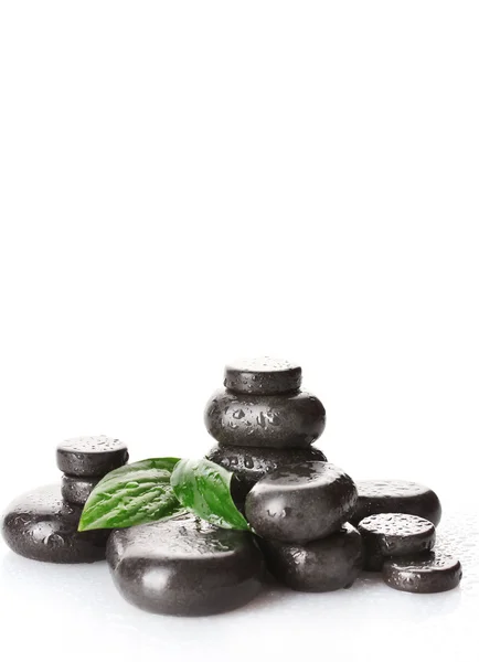 Spa stones with drops and green leaves isolated on white — Stock Photo, Image