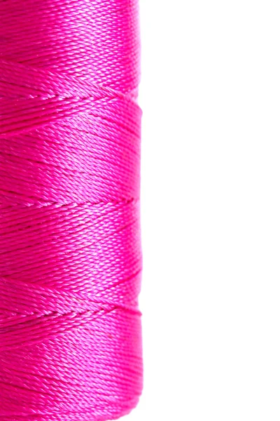 Pink bobbin thread isolated on white — Stock Photo, Image