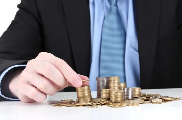 Empresário colocar moedas isoladas em branco — Fotografia de Stock