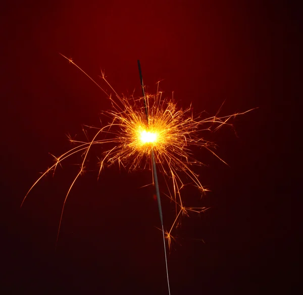 Beautiful sparkler on red background Stock Photo