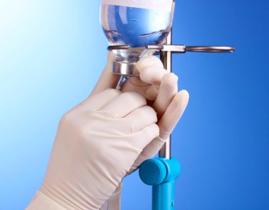 Nurse doing infusion on blue background clipart