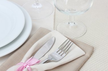 Table setting with fork, knife, plates, and napkin clipart