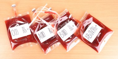 Bags of blood and infusion on wooden background clipart