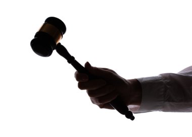 Silhouette of woman's hand with gavel isolated on white clipart