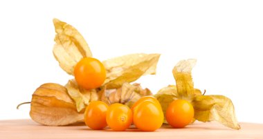 Physalis heap on wooden table on white background clipart